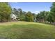 Expansive backyard with mature trees and lush green lawn at 75 Auburn Rd, Auburn, GA 30011