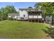 Home exterior with spacious backyard, deck, and screened in porch at 75 Auburn Rd, Auburn, GA 30011