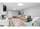 Finished basement featuring new floors, a comfortable sitting area, and modern lighting at 75 Auburn Rd, Auburn, GA 30011