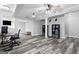 Finished basement featuring wood floors, office area, and storage shelves at 75 Auburn Rd, Auburn, GA 30011