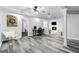 Finished basement with hardwood floors, featuring a dart board, office area, and a fireplace at 75 Auburn Rd, Auburn, GA 30011