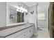 Bathroom featuring a glass bowl sink and granite countertop vanity, with neutral paint and tile flooring at 75 Auburn Rd, Auburn, GA 30011