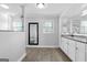 Bright bathroom featuring modern granite vanity, mirrors, glass shower, and neutral walls at 75 Auburn Rd, Auburn, GA 30011