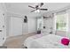 Neutral bedroom showcasing natural light, ceiling fan, carpeted flooring, and closet space at 75 Auburn Rd, Auburn, GA 30011