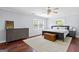 Light-filled bedroom with hardwood floors, ceiling fan, dresser, and a plush rug at 75 Auburn Rd, Auburn, GA 30011