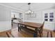 Dining room features a rustic wood table, stylish light fixture, and wainscoting detail at 75 Auburn Rd, Auburn, GA 30011