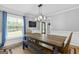 Cozy dining room features a rustic wood table and a window with natural light at 75 Auburn Rd, Auburn, GA 30011