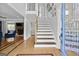 Inviting foyer with hardwood floors, staircase, and view into the living room at 75 Auburn Rd, Auburn, GA 30011