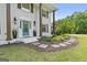 Close-up of a front porch with a blue door, stone pathway, and well-manicured flower beds at 75 Auburn Rd, Auburn, GA 30011
