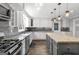 Spacious kitchen boasting stainless steel appliances, white cabinets, granite countertops, and a kitchen island at 75 Auburn Rd, Auburn, GA 30011
