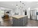 Open kitchen concept with an island, stainless steel refrigerator and access to the dining area at 75 Auburn Rd, Auburn, GA 30011