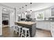 Bright kitchen with an island, white cabinets, stainless appliances, and stylish tile backsplash at 75 Auburn Rd, Auburn, GA 30011