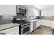 Well-lit kitchen showcasing granite countertops, stainless steel appliances and ample white cabinetry at 75 Auburn Rd, Auburn, GA 30011