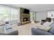 Comfortable living room showcasing a stone fireplace, cozy seating and a sliding glass door at 75 Auburn Rd, Auburn, GA 30011