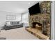 Cozy living room featuring a stone fireplace, a comfortable sofa and natural light from the windows at 75 Auburn Rd, Auburn, GA 30011