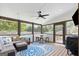 Inviting screened porch with a ceiling fan, comfortable seating, and views of the outdoors at 75 Auburn Rd, Auburn, GA 30011