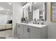 Bathroom with double vanity, granite countertops, framed mirrors, black hardware, and decorative accents at 1770 Atherton Dr, Decatur, GA 30035