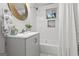 Well-lit bathroom with a single vanity, a white tiled shower/bathtub combo, and contemporary fixtures at 1770 Atherton Dr, Decatur, GA 30035