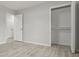 Spacious bedroom with wood-look flooring, an open closet with shelving, and access to another room at 1770 Atherton Dr, Decatur, GA 30035