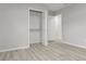 Clean bedroom with wood-look flooring, an open closet with shelving, and neutral wall colors at 1770 Atherton Dr, Decatur, GA 30035