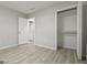 Bright bedroom featuring wood-look flooring, neutral wall colors, an open closet, and modern decor at 1770 Atherton Dr, Decatur, GA 30035