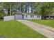 Home with a concrete driveway, lush lawn, and a freshly painted gray and white exterior at 1770 Atherton Dr, Decatur, GA 30035