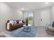 Stylish living room with modern decor, a leather sofa, and decorative wall paneling at 1770 Atherton Dr, Decatur, GA 30035
