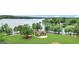 Aerial view of a pavilion and recreational area along the lake, surrounded by trees at 407 Blue Smoke Trl, Peachtree City, GA 30269