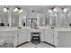 Bright bathroom with a vanity, a white countertop, and a large mirror with a seated vanity area at 407 Blue Smoke Trl, Peachtree City, GA 30269
