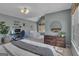 Bedroom with a desk area, a comfortable bed, and a full dresser at 407 Blue Smoke Trl, Peachtree City, GA 30269
