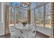 Bright dining area with large windows, a view of the trees, and a modern table with seating for four at 407 Blue Smoke Trl, Peachtree City, GA 30269
