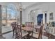 Dining room with hardwood floor, wainscoting, and large arched window at 407 Blue Smoke Trl, Peachtree City, GA 30269