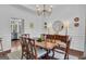 Elegant dining room with hardwood floors, wainscoting, and designer lighting at 407 Blue Smoke Trl, Peachtree City, GA 30269