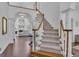 Grand foyer with a curved staircase, hardwood floors, and views to the living room with a fireplace at 407 Blue Smoke Trl, Peachtree City, GA 30269