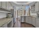 Open kitchen with granite countertops, stainless appliances and breakfast nook at 407 Blue Smoke Trl, Peachtree City, GA 30269