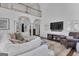 Open-concept living room with large sectional sofa, fireplace, and a view of the upper-level balcony at 407 Blue Smoke Trl, Peachtree City, GA 30269