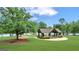 Community pavilion with picnic tables, benches and a beautiful lawn area, perfect for gatherings at 407 Blue Smoke Trl, Peachtree City, GA 30269