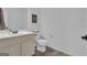 Clean powder room with a simple vanity, toilet, and neutral walls, offering a practical and tidy space at 407 Blue Smoke Trl, Peachtree City, GA 30269