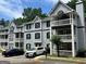 Apartment building with gray siding, black shutters, and white trim, complemented by well-maintained landscaping at 3480 Shepherds Path, Decatur, GA 30034