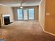 Spacious living room with neutral walls, plush carpet, a fireplace, and sliding glass doors to a patio at 3480 Shepherds Path, Decatur, GA 30034