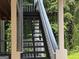 Outdoor staircase surrounded by lush greenery, offering access to the property at 3480 Shepherds Path, Decatur, GA 30034
