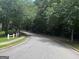 A scenic street view of the community, lined with trees and white picket fences at 3480 Shepherds Path, Decatur, GA 30034