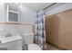 Bathroom with beige tile shower, blue and white curtain, and white vanity at 3626 Buford # C1, Brookhaven, GA 30329
