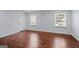 Spacious bedroom features two windows for natural light and hardwood flooring at 3626 Buford # C1, Brookhaven, GA 30329