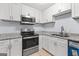 This kitchen features white cabinets, stainless steel appliances, and granite countertops at 3626 Buford # C1, Brookhaven, GA 30329