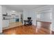 Modern kitchen with white cabinets and stainless appliances next to hardwood floored living room at 3626 Buford # C1, Brookhaven, GA 30329