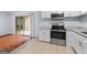Open kitchen next to patio with tile floor, stainless steel appliances, and granite countertops at 3626 Buford # C1, Brookhaven, GA 30329
