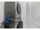 Stacked washer and dryer appliance in updated laundry room with built-in shelving at 3626 Buford # C1, Brookhaven, GA 30329