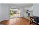 Hardwood floors in an open floor plan leads to sliding doors and a modern kitchen at 3626 Buford # C1, Brookhaven, GA 30329