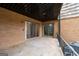 Covered porch with metal railing and brick siding shows two sliding glass door entrances at 3626 Buford # C1, Brookhaven, GA 30329